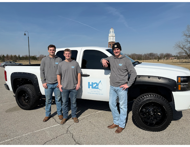 H2O Sprinkler Co. team standing with company truck